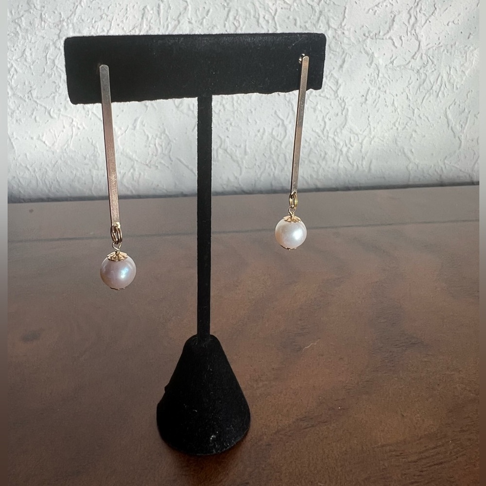 Pearl and gold filled with a studded back.